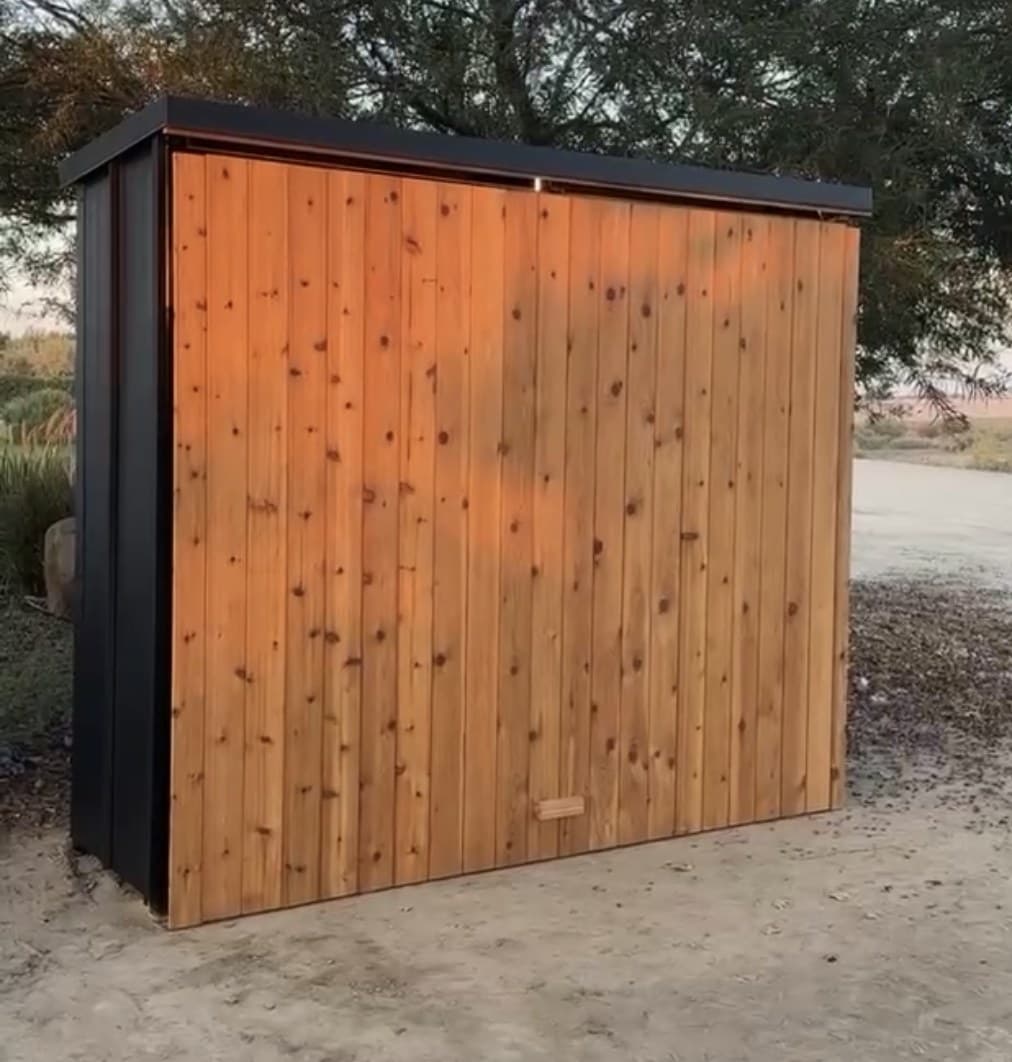 Enclosed outdoor kitchen pod closed and weather sealed, showing the vertical cedar slat front